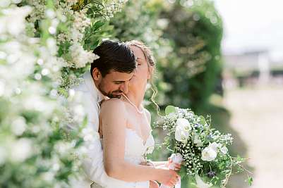 Les mariés lors de la séance photo de couple dans entourés de jasmin